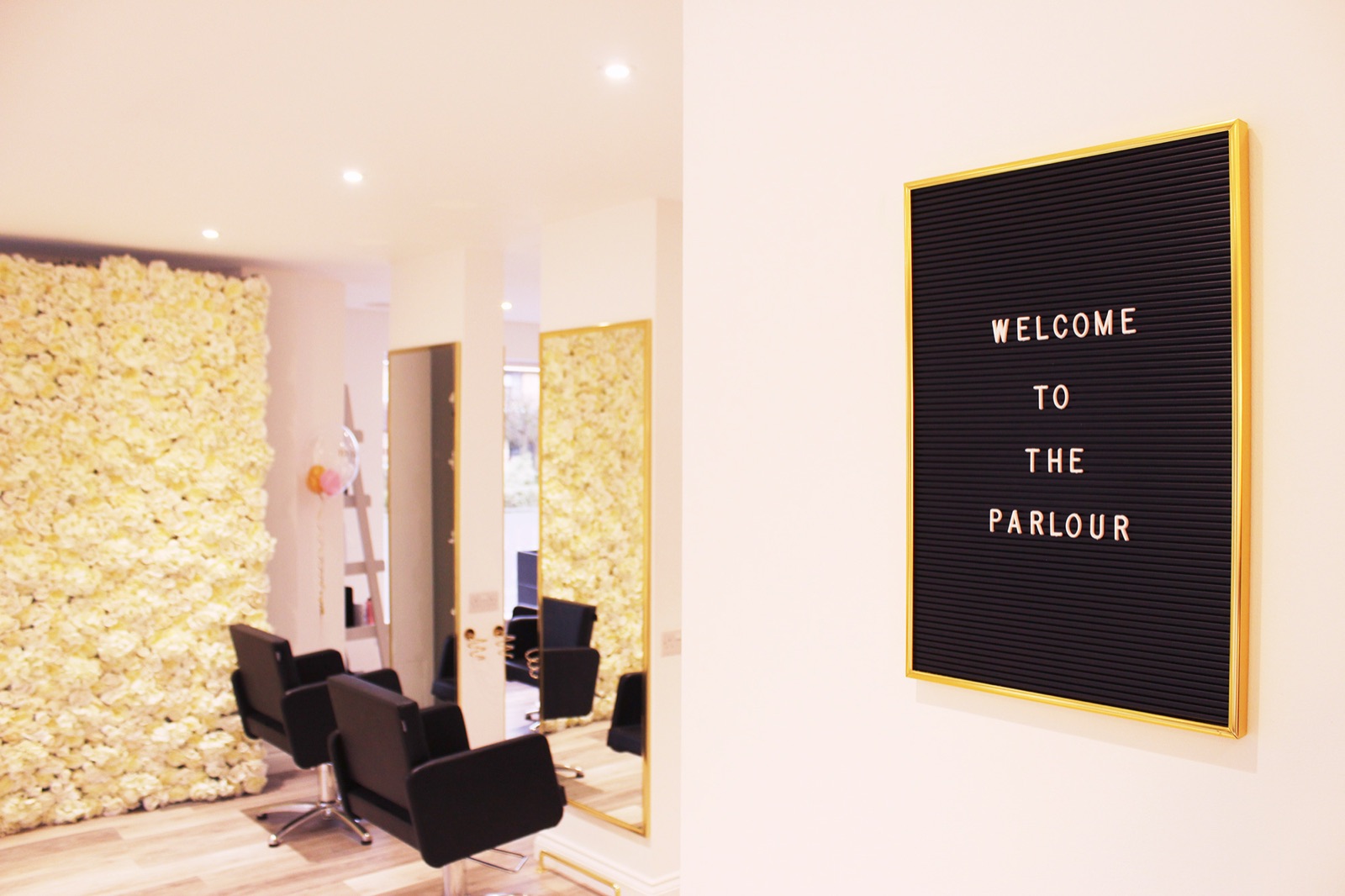Inside The Parlour: a flower wall, styling chairs and a 'Welcome to The Parlour' letter board